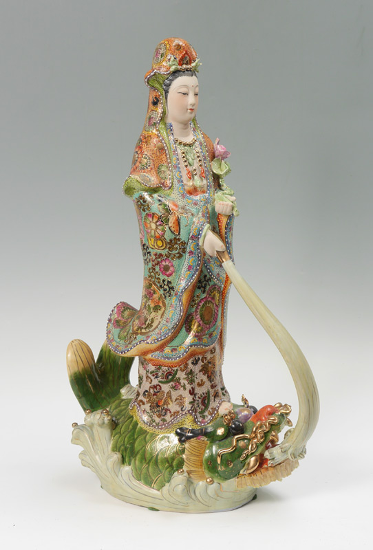 Appraisal: CHINESE POLYCHROME FIGURE OF QUAN YIN ON FISH Polychrome decorated