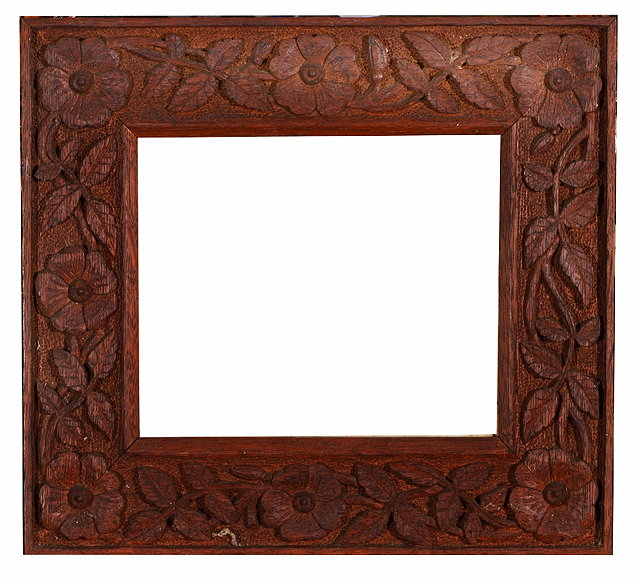 Appraisal: AN OAK FRAME the border carved with flowering foliage in