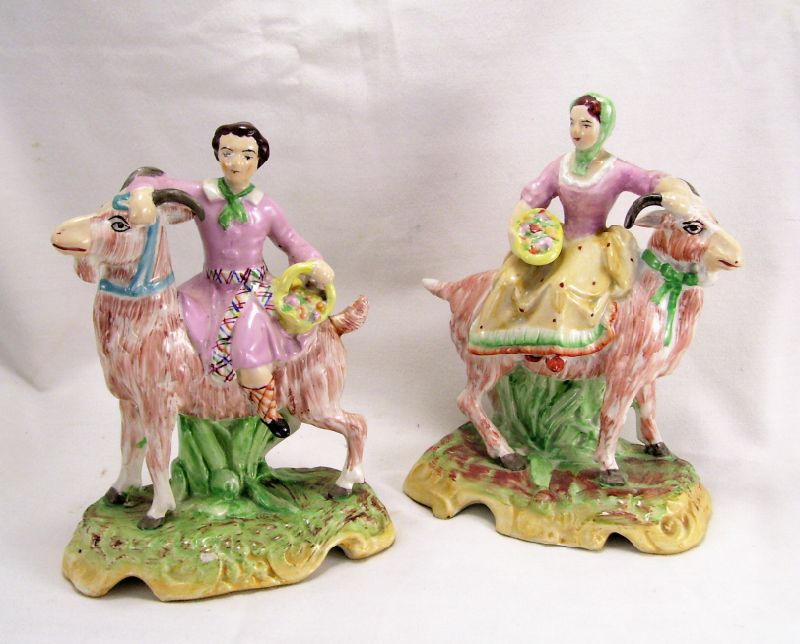 Appraisal: Pair of Staffordshire Figures Seated figures upon the back of