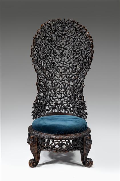 Appraisal: Anglo-Indian padouk parlor chair circa The high arched backrest carved