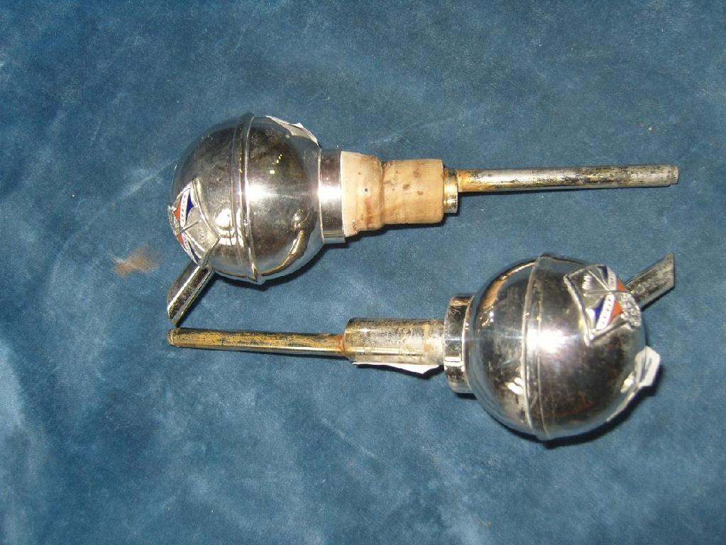 Appraisal: Two silver plated wine bottle pourers with enamel decoration of