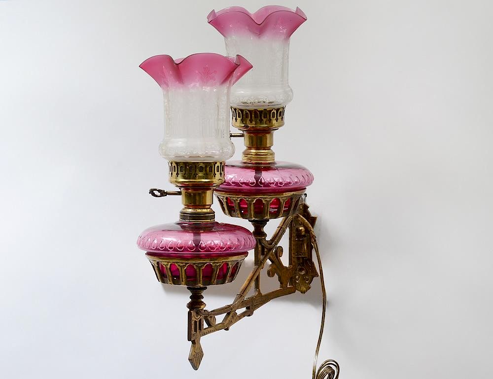 Appraisal: VINTAGE BRASS TWO LIGHT SCONCE With cranberry glass kerosene containers