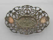 Appraisal: A white metal stamped cast sweetmeats dish with pierced scrolling