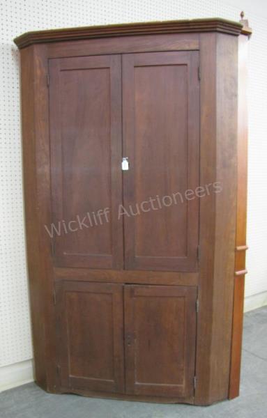 Appraisal: An antique blind-door corner cupboard hand-chamfered doors walnut doors with