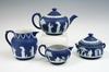 Appraisal: TEA SERVICE - Four piece white on blue Wedgwood jasperware