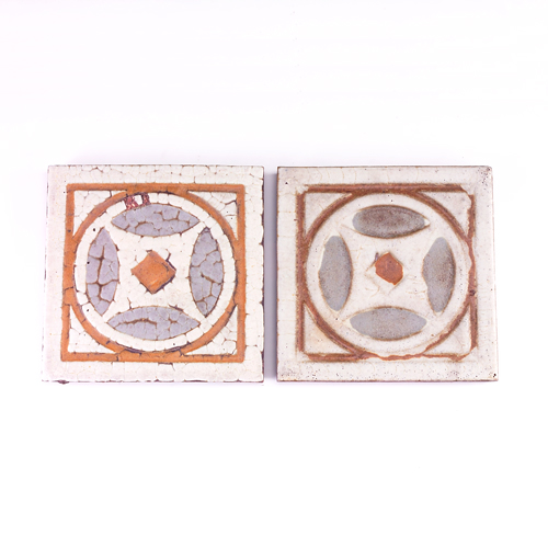 Appraisal: GRUEBY Two geometric tiles with medallion center covered in white