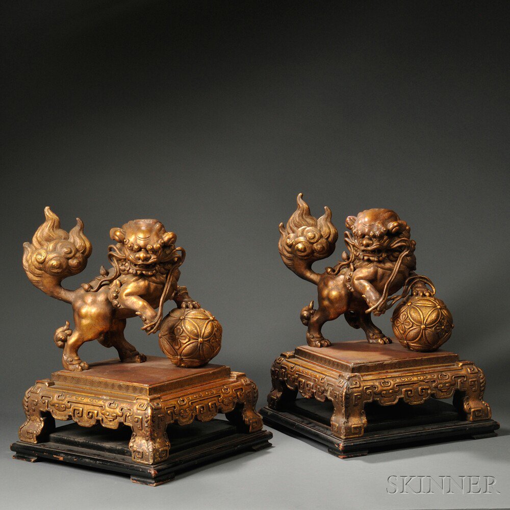 Appraisal: Two Gilt Wood Foo Lions China each with one paw