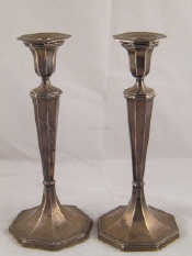 Appraisal: A pair of silver candlesticks of tapering octagonal section rising