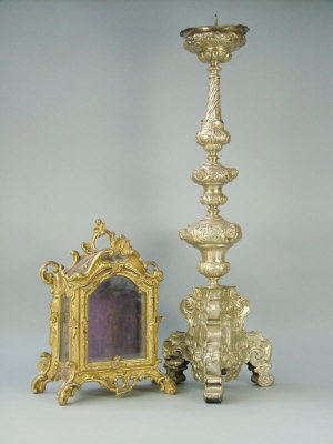 Appraisal: A Continental plated pricket candlestick th century with cherub mask