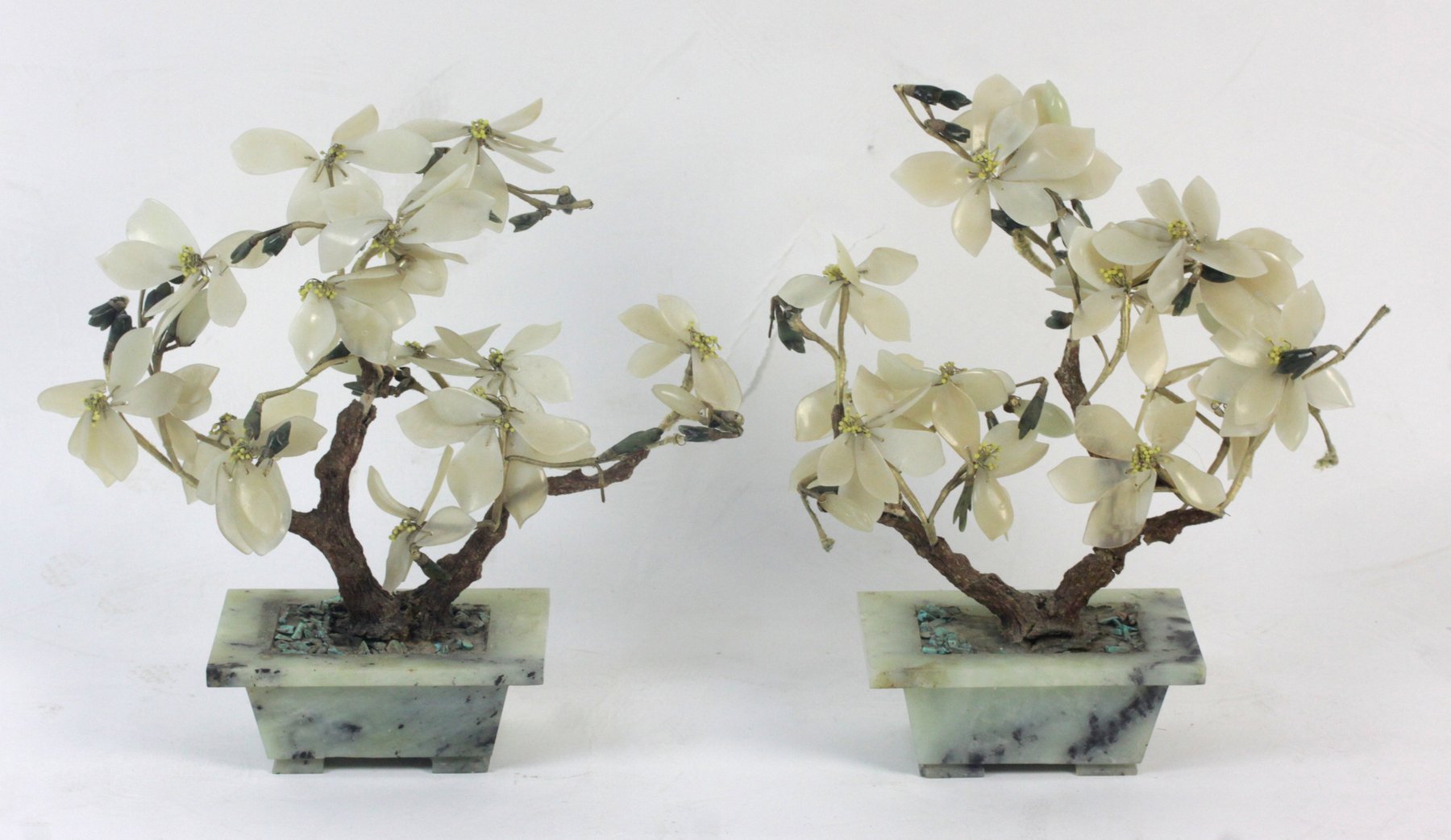 Appraisal: A pair of Chinese hardstone and soapstone flowering bushes in