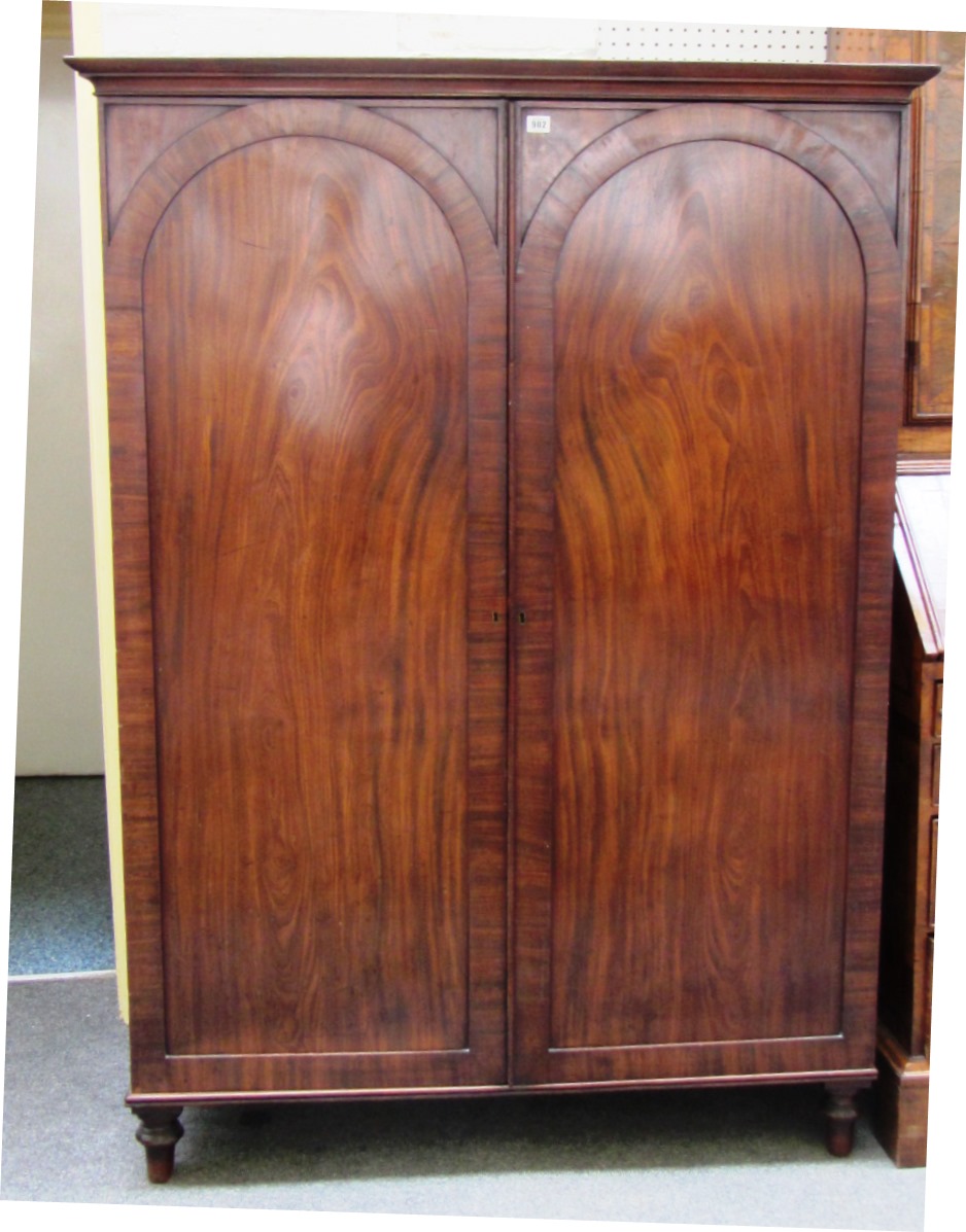 Appraisal: A th century figured mahogany wardrobe the pair of arch