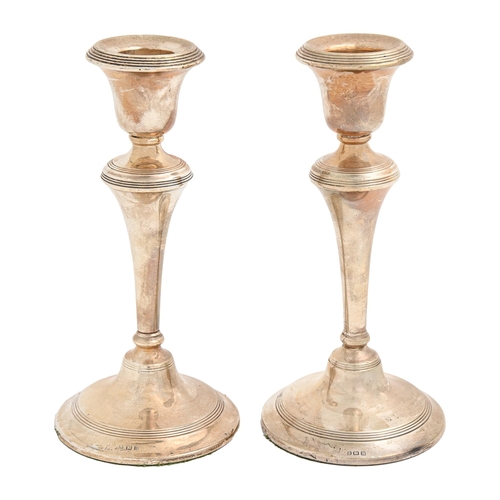 Appraisal: A pair of George V silver candlesticks with reeded bands