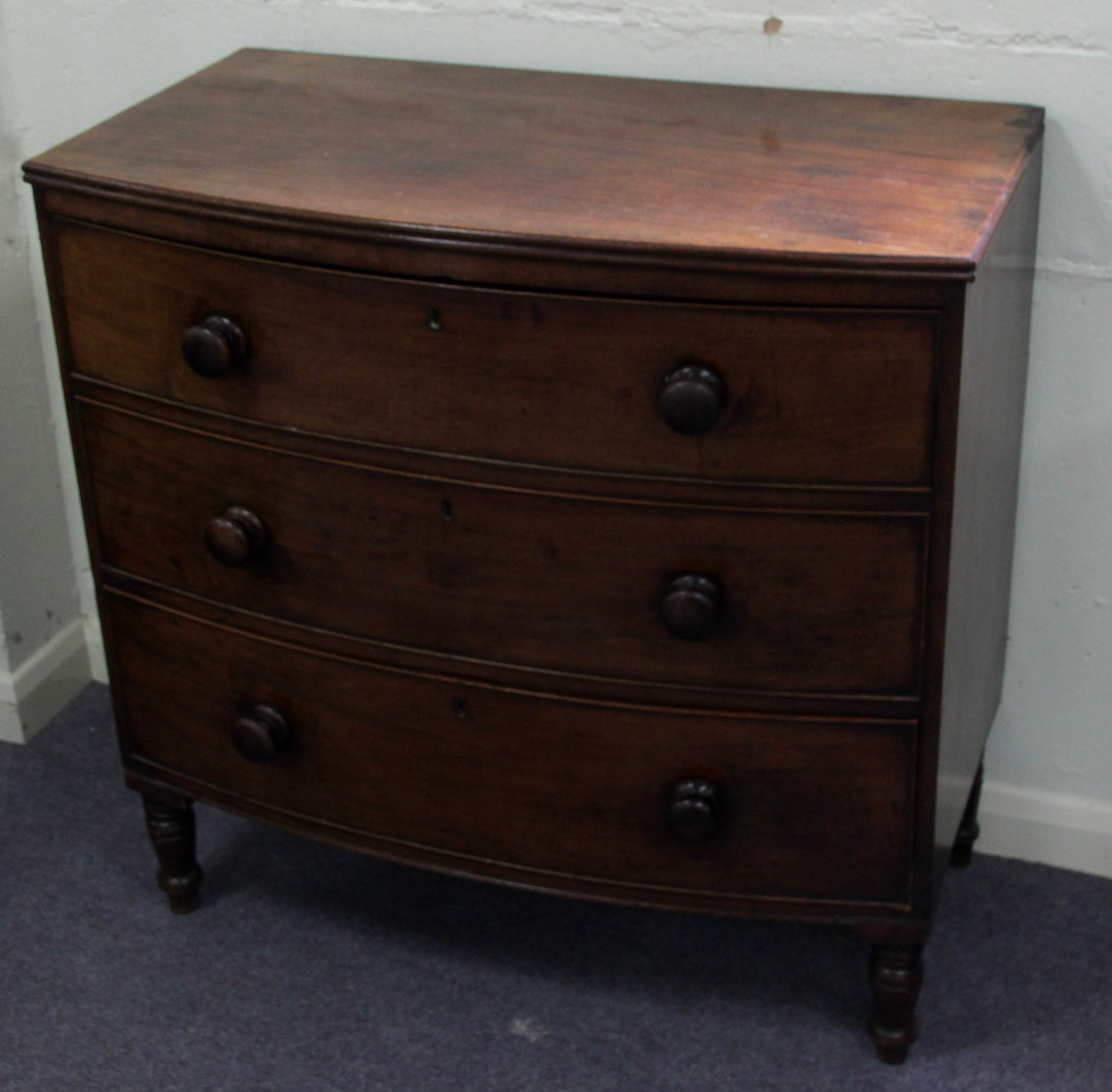 Appraisal: A th Century mahogany bowfronted chest fitted three long drawers