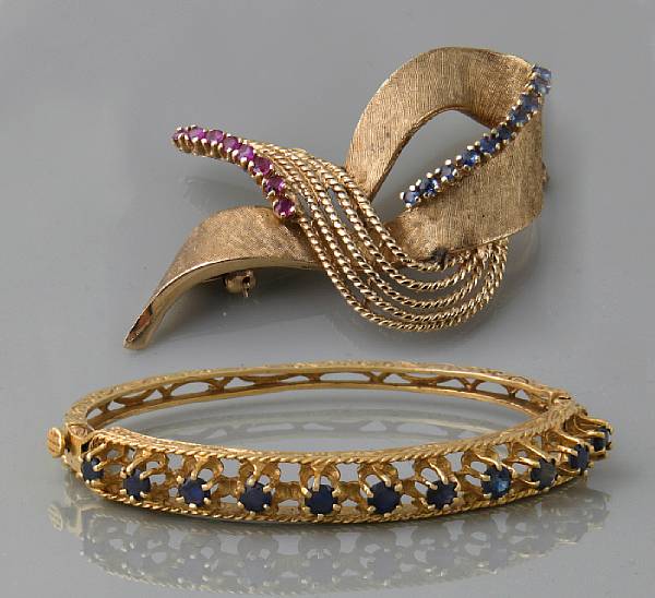 Appraisal: A sapphire and k gold bangle together with a sapphire