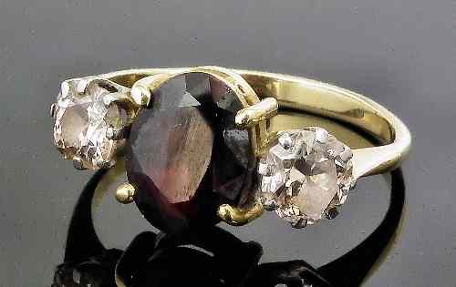 Appraisal: An Edwardian gold coloured metal mounted three stone garnet and