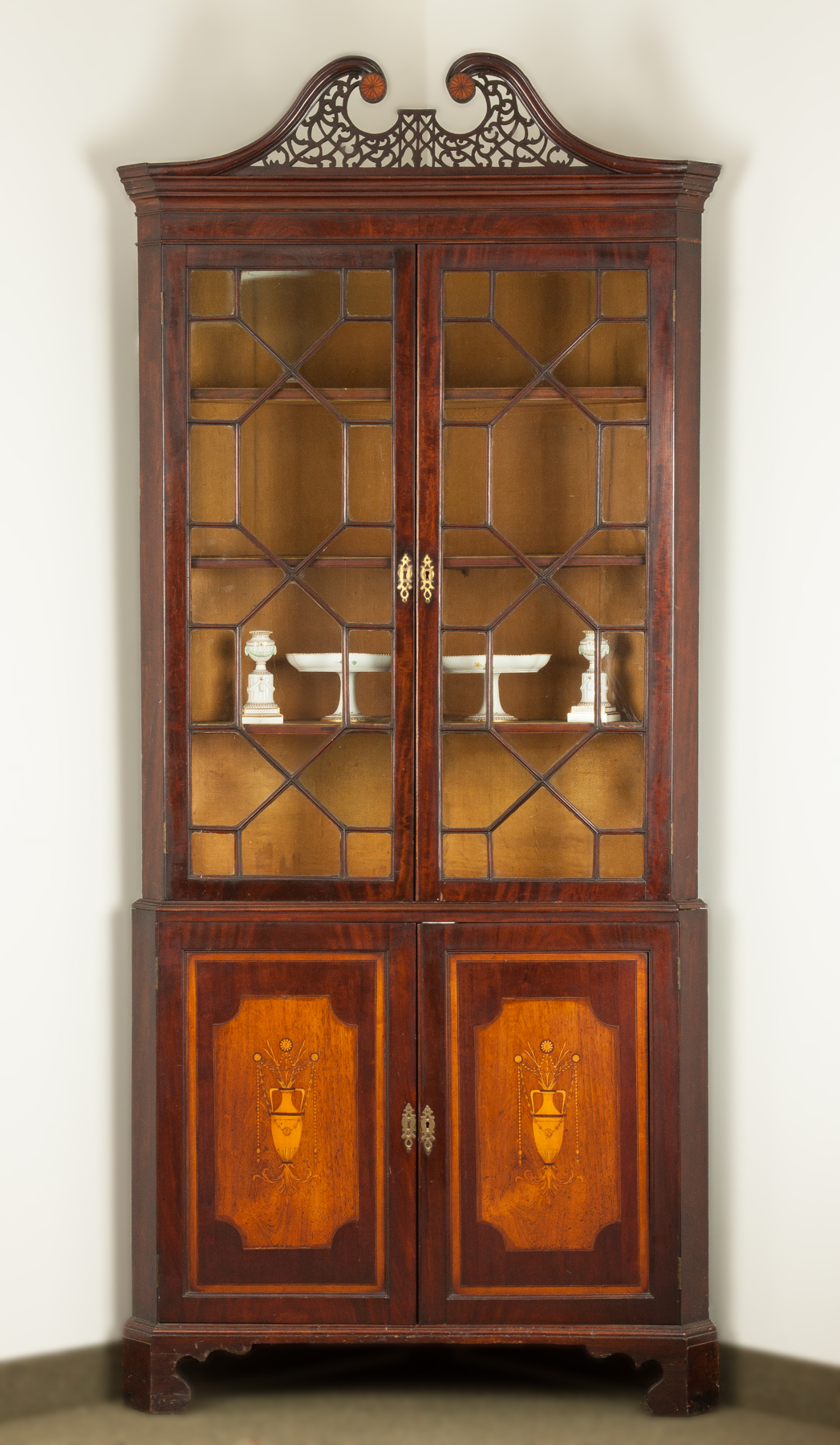 Appraisal: Georgian Corner Cupboard Late th cent Satinwood inlaid mahogany Pierced