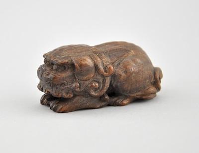 Appraisal: Recumbent Shizui Lion Wood Netsuke Depicting a resting Shizui lion