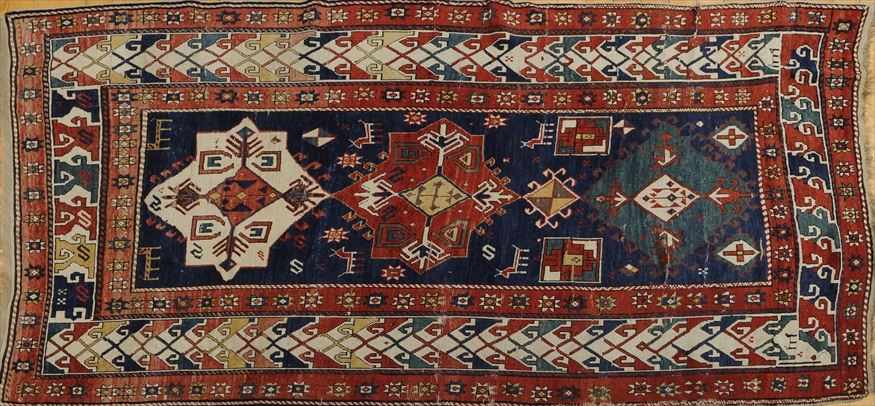 Appraisal: CAUCASIAN RUG The central ground woven with three medallions within