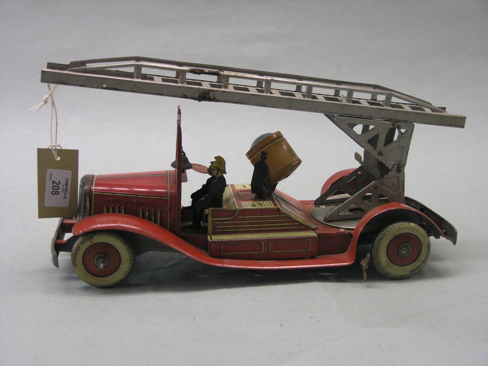 Appraisal: An English pre-war lithographed tinplate and clockwork fire engine probably