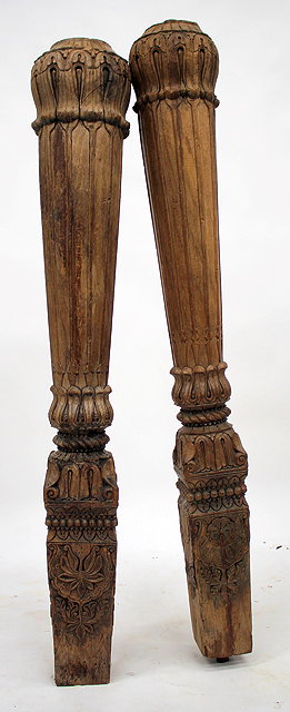 Appraisal: A PAIR OF INDIAN CARVED HARDWOOD PILLARS cylindrical to square