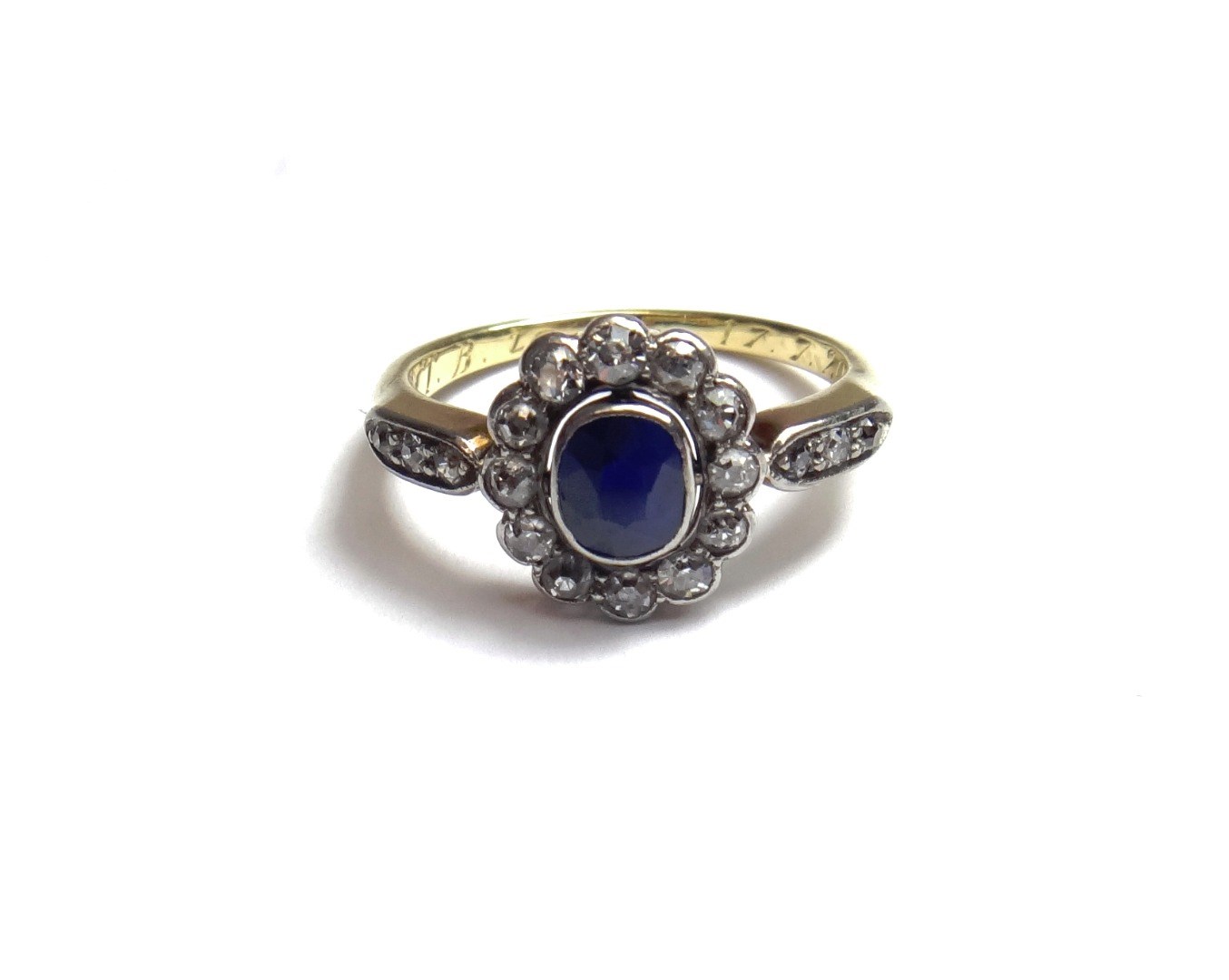 Appraisal: A gold sapphire and diamond set oval cluster ring collet