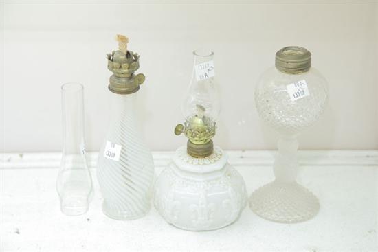 Appraisal: GROUP OF THREE MINIATURE GLASS OIL LAMPS Including one clear