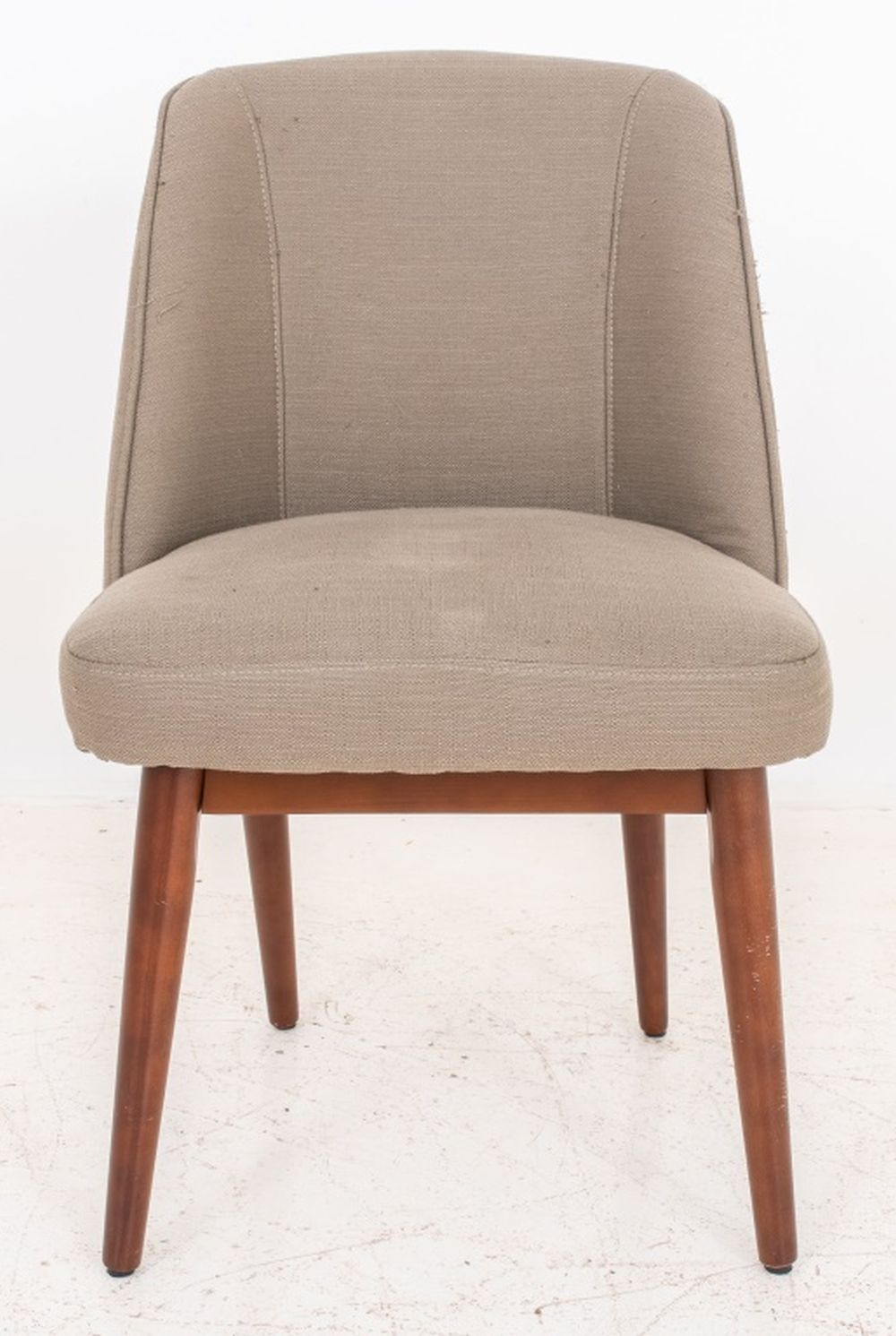 Appraisal: MODERN UPHOLSTERED BEIGE CHAIR Modern upholstered beige chair raised on