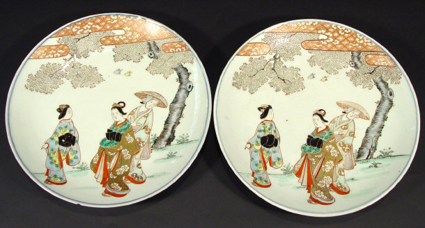 Appraisal: Pair of oriental porcelain chargers painted and gilded with geisha