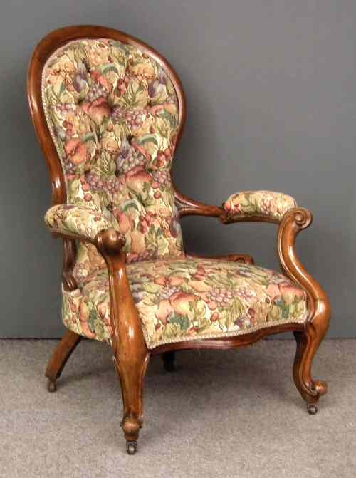 Appraisal: A Victorian walnut showwood framed spoon back nursing chair the