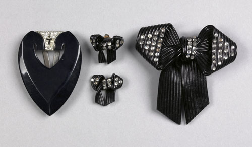 Appraisal: Black celluloid bow pin and earrings with rhinestone decoration together