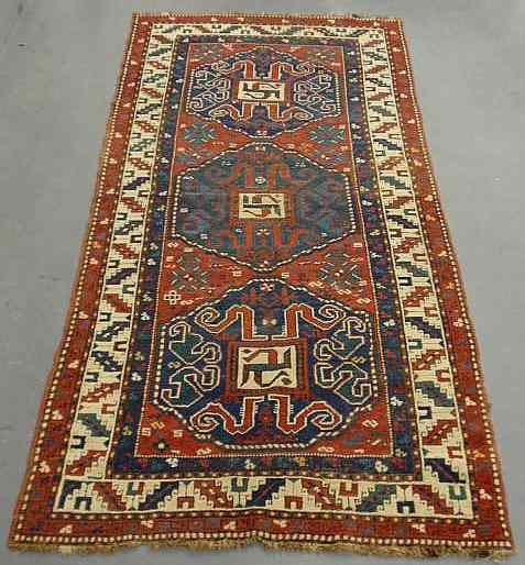 Appraisal: Kazak oriental hall carpet with three blue medallions red field