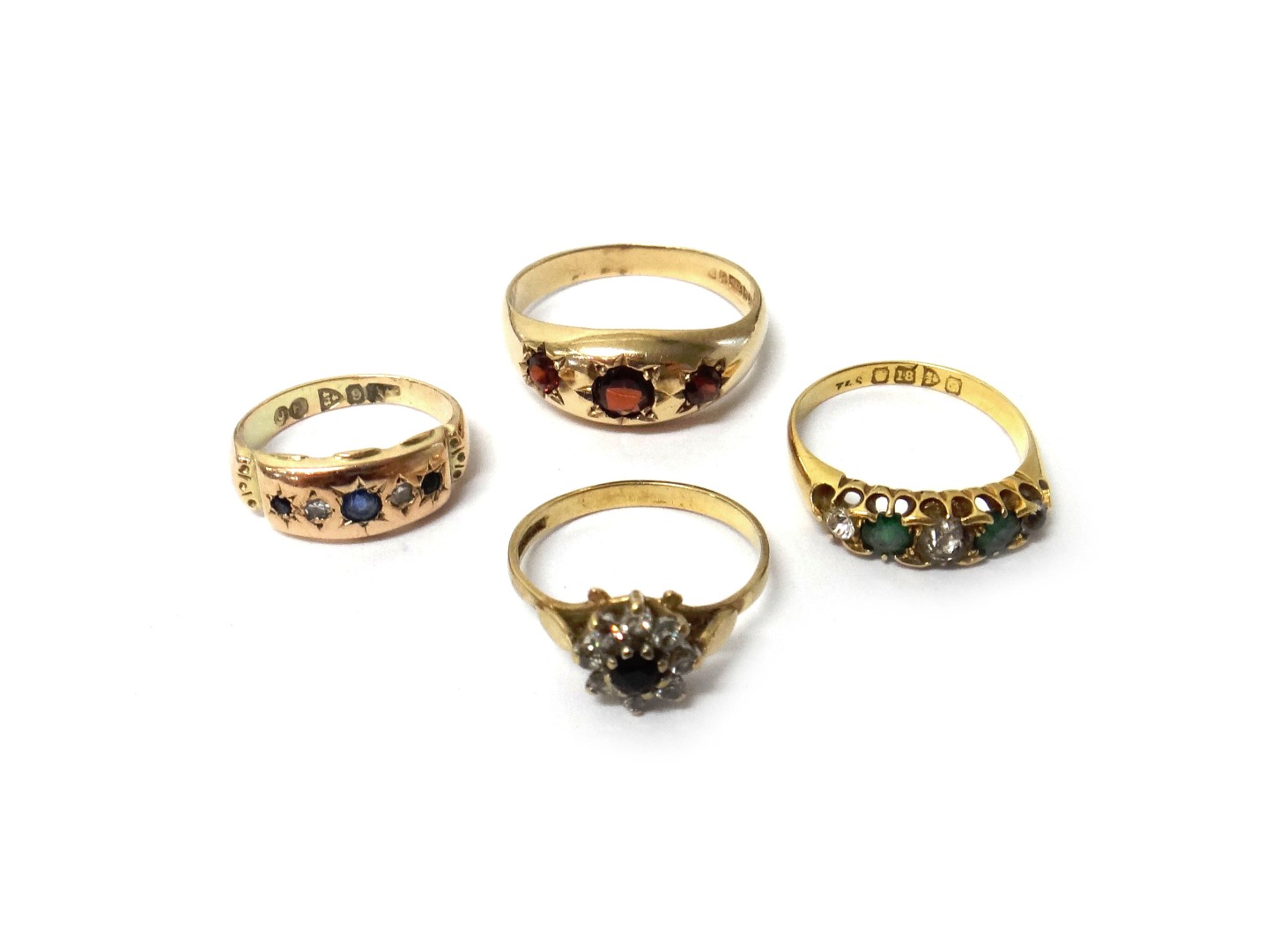 Appraisal: A ct gold and garnet set three stone ring an