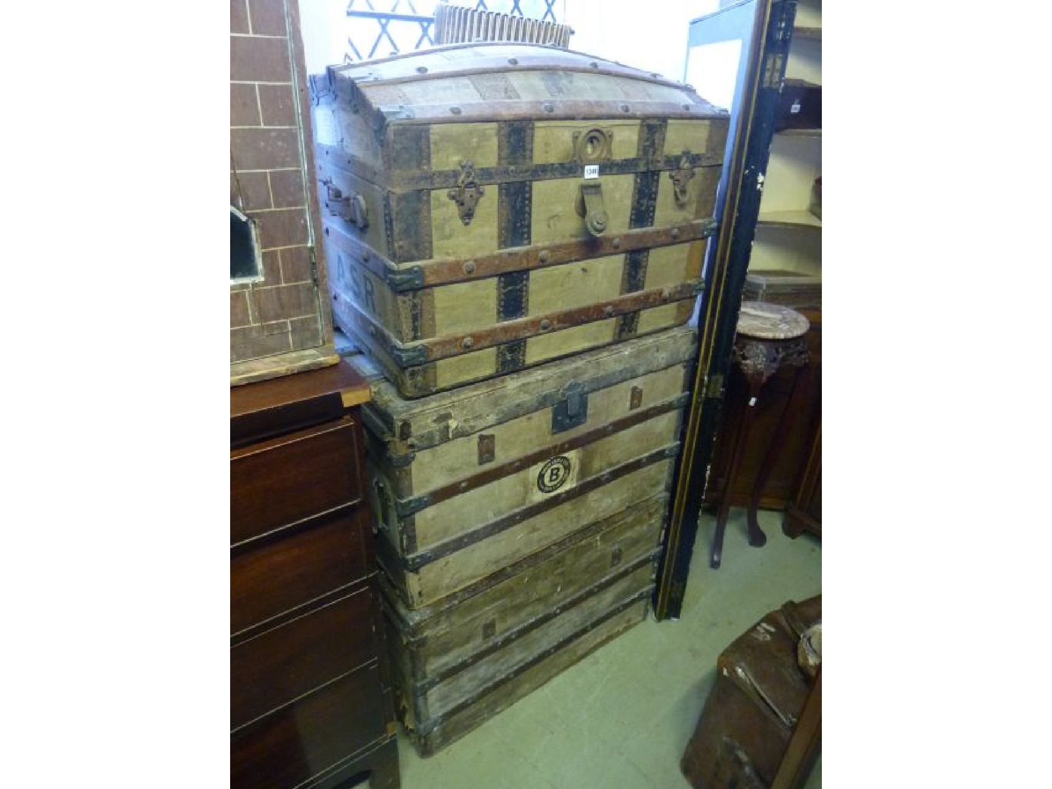 Appraisal: Three vintage travelling trunks in green canvas timber overlaid with