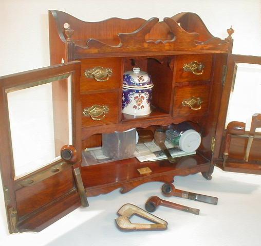 Appraisal: An Edwardian oak smokers cabinet with gallery top and broken