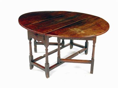 Appraisal: An th century oak gateleg table the boarded oval top