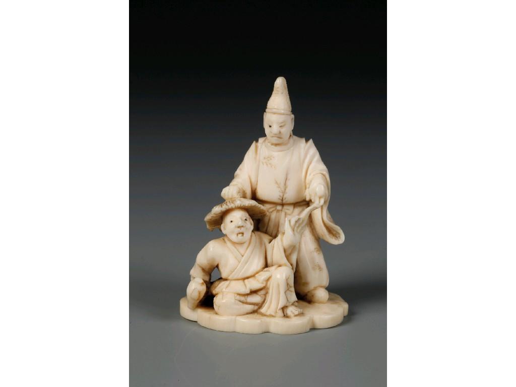 Appraisal: A JAPANESE IVORY OKIMONO of two actors the base with