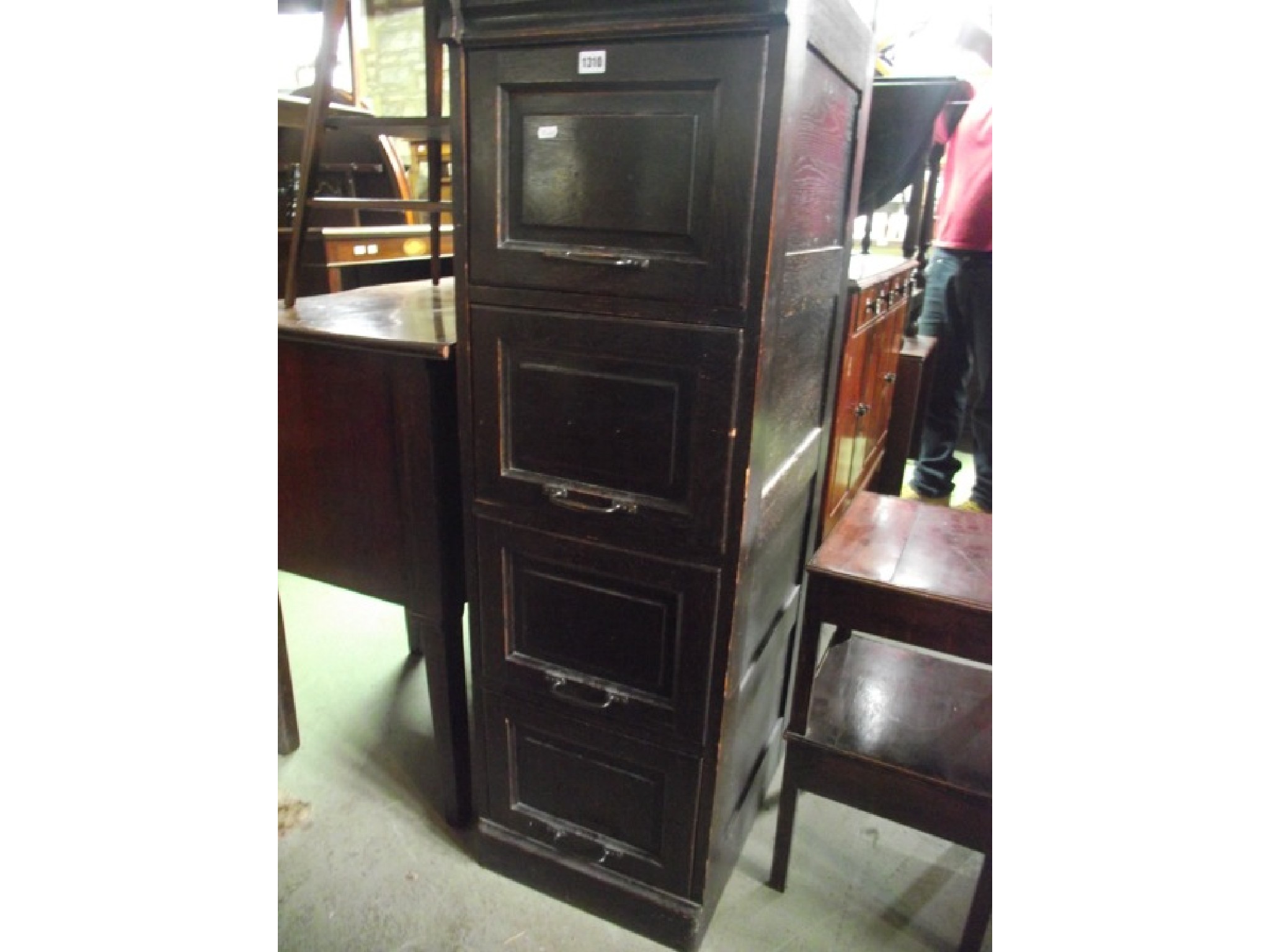 Appraisal: An early th century dark stained oak four drawer floorstanding