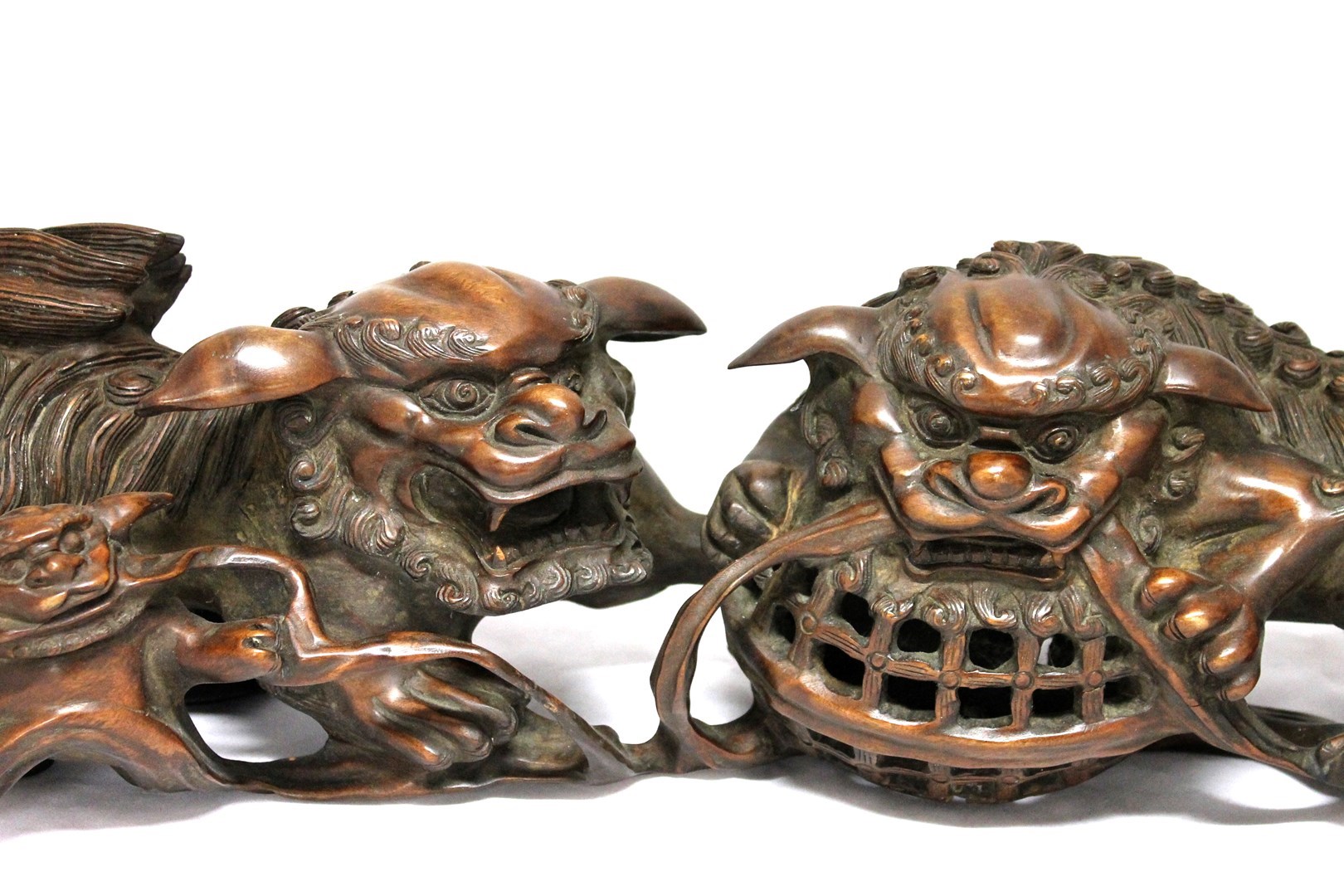 Appraisal: A Chinese hardwood group of two Buddhist lions with a