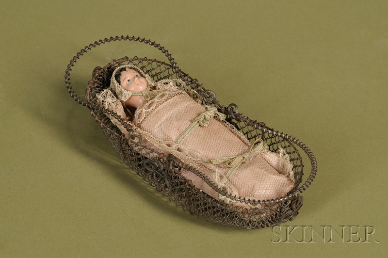 Appraisal: Squeak Toy Baby in Wire Basket Germany c papier-mache socket