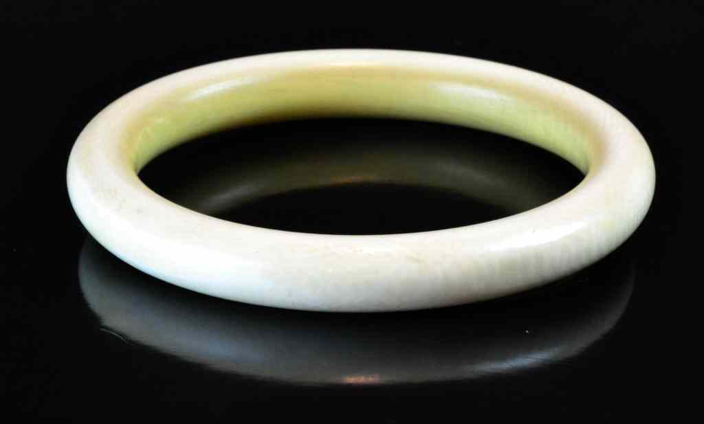 Appraisal: A Carved Chinese Ivory BraceletThe bangle bracelet left uncarved but