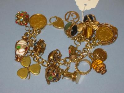 Appraisal: A CT GOLD CHARM BRACELET the flattened curb links hanging