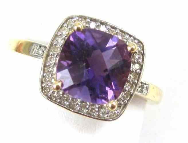 Appraisal: AMETHYST DIAMOND AND FOURTEEN KARAT GOLD RING set with round-cut