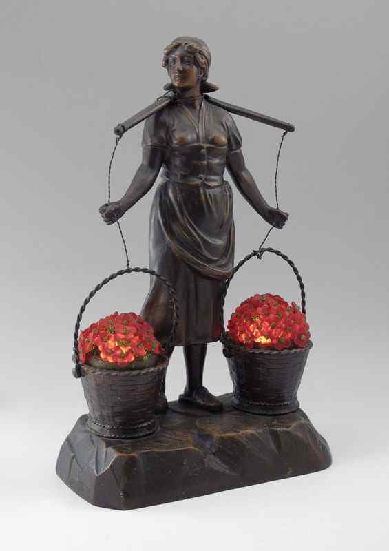 Appraisal: CAST METAL FIGURAL LAMP Maiden with baskets the light illuminates