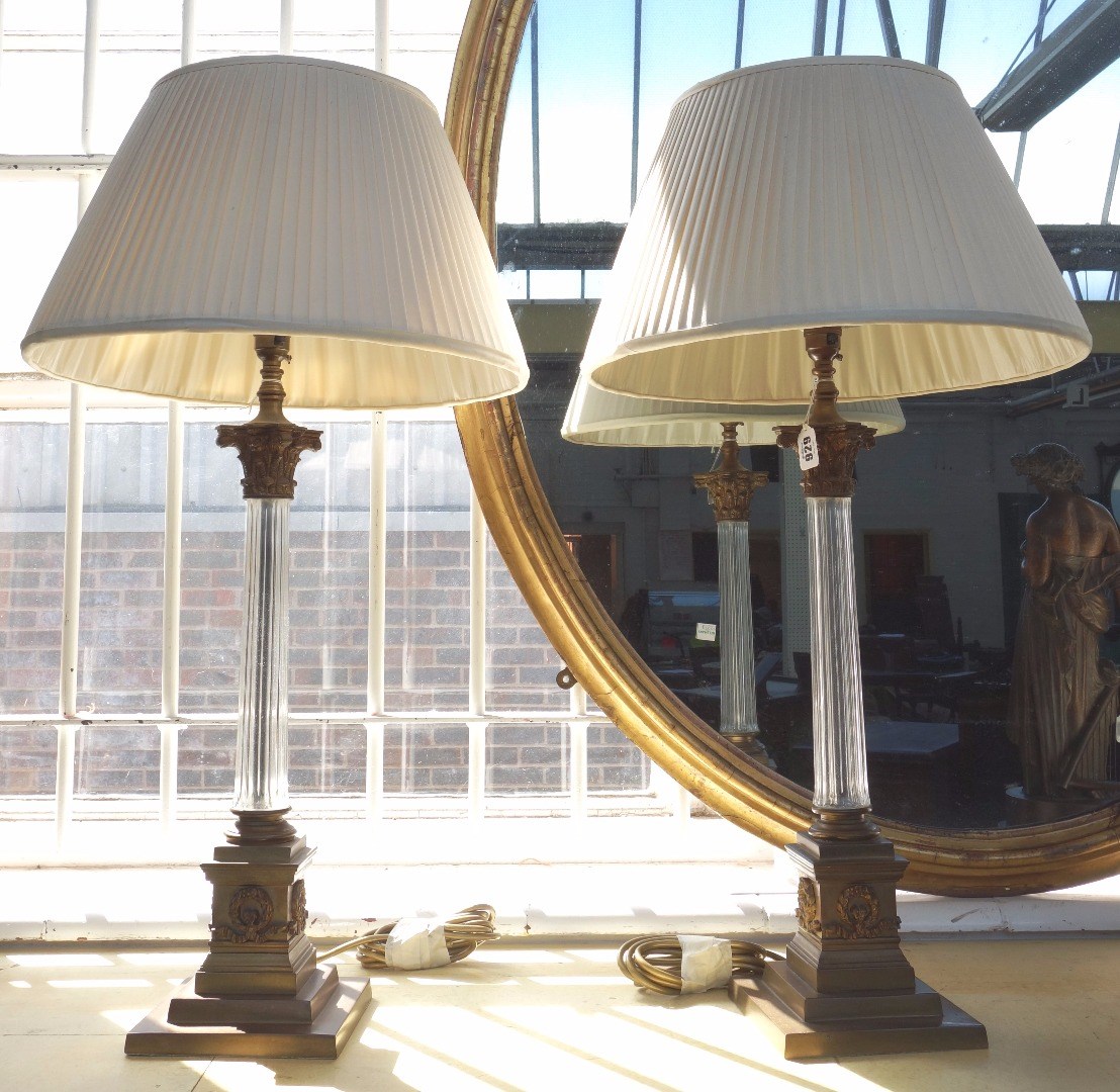 Appraisal: A pair of brass and glass mounted table lamps th