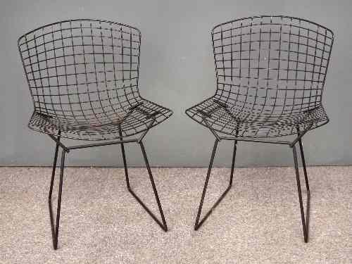 Appraisal: A pair of s ebonised metal wire framed dining chairs