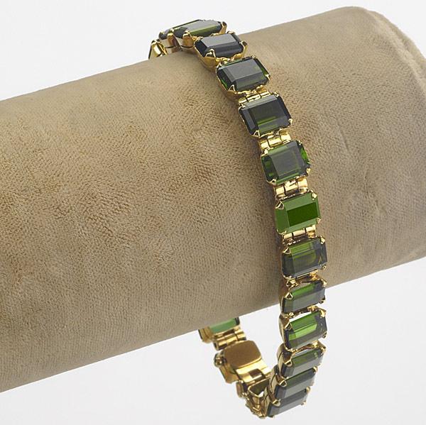 Appraisal: TOURMALINE AND K BRACELET Twenty-three emerald cut green tourmalines prong