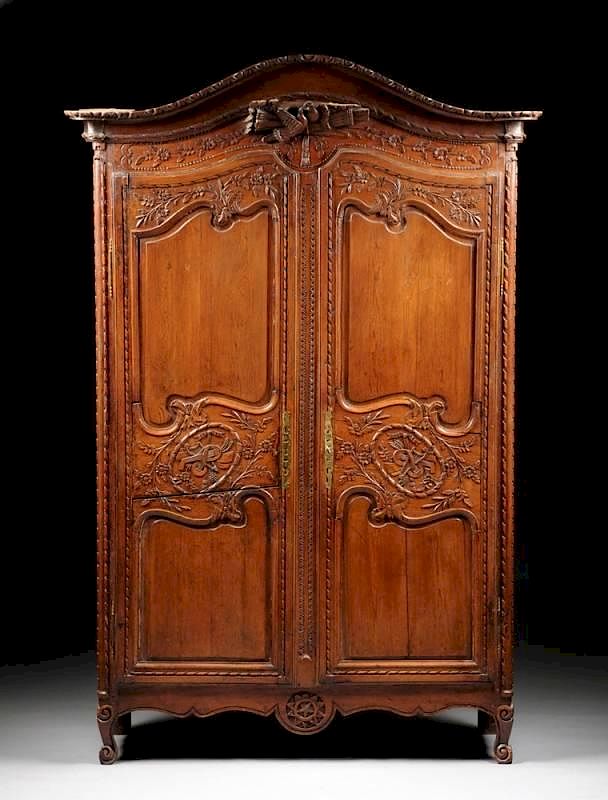 Appraisal: A FRENCH PROVINCIAL CARVED WAXED PINE ARMOIRE FIRST HALF TH