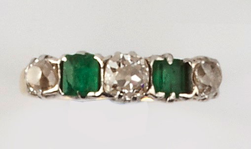 Appraisal: AN EMERALD AND DIAMOND HALF HOOP RING alternately set with