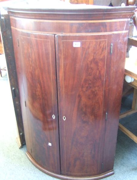 Appraisal: A Regency mahogany and line inlaid bowfront hanging corner cupboard