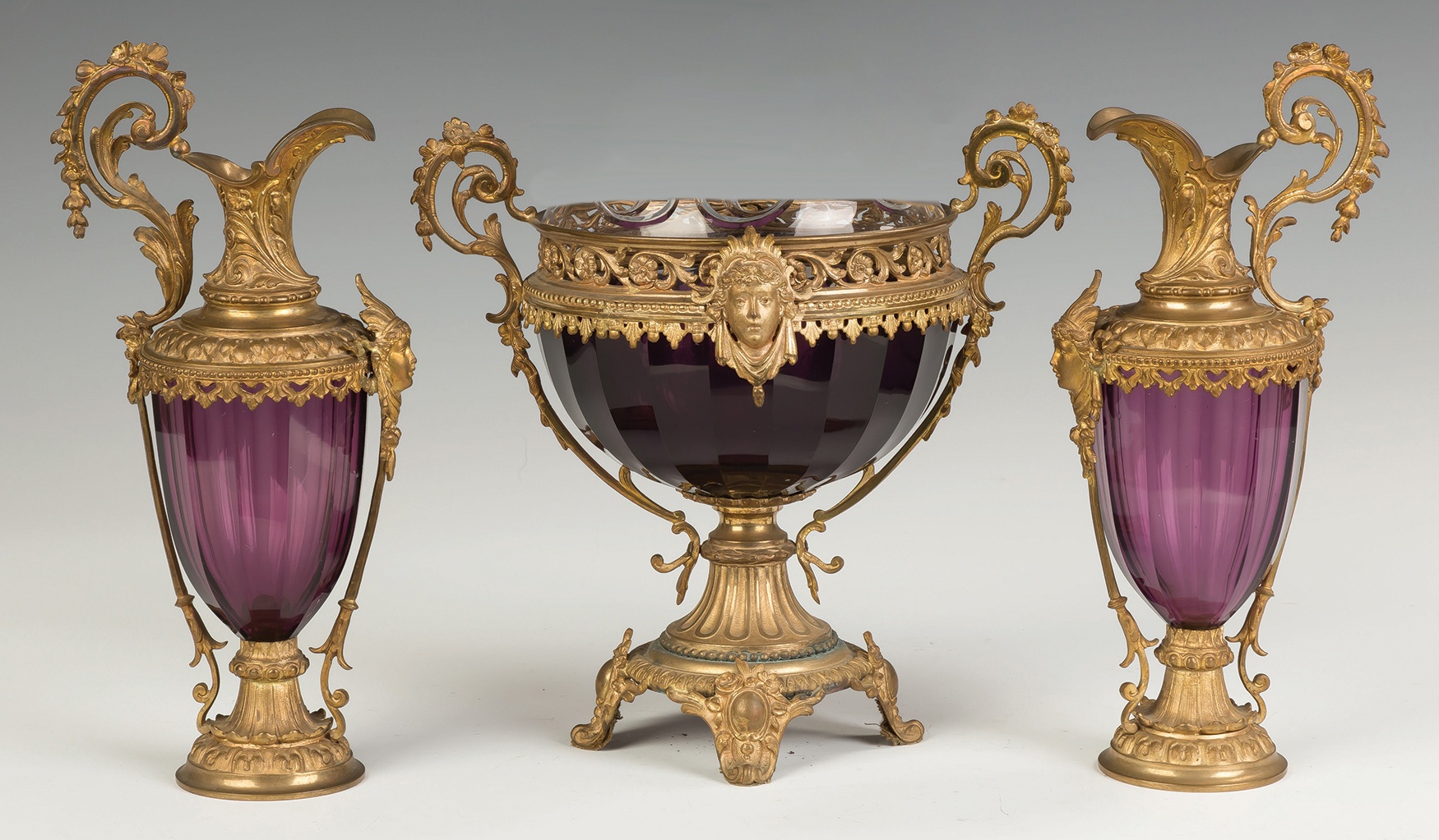 Appraisal: Victorian Ewers and Urn Victorian ewers and urn amethyst glass